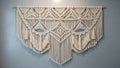Intricate macram wall hanging featuring geometric patterns with Royalty Free Stock Photo