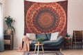intricate mandala tapestry hanging on the wall of bohemian home