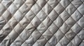 A close-up of a quilted blanket texture