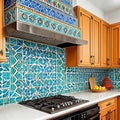 Intricate patterns of a Moroccan-inspired mosaic tile backsplash in a kitchen. Royalty Free Stock Photo