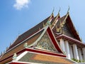 Intricate roof details of the Wat Pho Temple with blue sky behind in Bangkok, Thailand Royalty Free Stock Photo