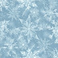 Intricate snowflakes are scattered across a light blue background, forming a seamless Royalty Free Stock Photo