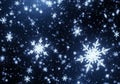 Intricate snowflakes with symmetric hexagonal patterns float Royalty Free Stock Photo