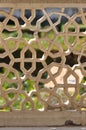 Intricate stone fence looking through to Amber Fort Gardens Jaipur India Royalty Free Stock Photo