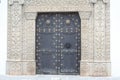 Intricate Stonework frames large metal door in Antigua Guatemala