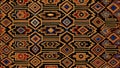 Abstract Kuba Cloth inspired geometry with vibrant earthy colors woven texture. Royalty Free Stock Photo