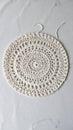 Intricate White Crochet Doily Detailed Round Pattern on Textured White Tabletop Royalty Free Stock Photo