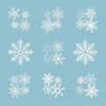 Intricate white snowflakes are arranged in a grid on a light blue backgr Royalty Free Stock Photo