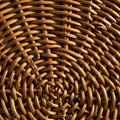 Intricate wicker pattern featuring tightly woven, light brown rattan strands. The circula Royalty Free Stock Photo