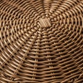 Intricate wickerwork pattern made of natural, light brown rattan. The interwoven design forms Royalty Free Stock Photo