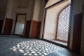 Intricate window lattice work creates a shadow on the floor of Humayans Tomb in Delhi India