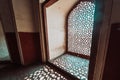 Intricate window lattice work creates a shadow on the floor of Humayans Tomb in Delhi India