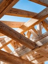 Intricate wooden beam structure showcasing craftsmanship and architectural design with natural timber framework against a clear Royalty Free Stock Photo