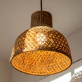 Intricate Woven Lamp Hanging from Ceiling Casting Warm Light in Home Decor Royalty Free Stock Photo