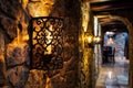 intricate wrought iron wall sconces lighting up a stonewalled meeting room