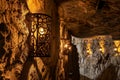 intricate wrought iron wall sconces lighting up a stonewalled meeting room