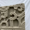 Intricately carved stone panel featuring geometric patterns and symbolic motifs. The Royalty Free Stock Photo