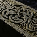 Intricately carved stone surface featuring Celtic knotwork patterns Royalty Free Stock Photo