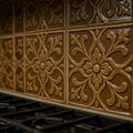 Intricately designed brown ceramic tiles form a decorative backsplash in a kitchen Royalty Free Stock Photo