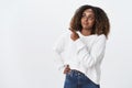 Intrigued pleased good-looking dark-skinned attractive plus-size female model white sweater look pointing upper left