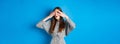 Intrigued young girl peeking through fingers with excitement, seeing interesting thing, standing on blue background Royalty Free Stock Photo