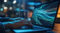 Close up of hands using a laptop displaying data visualization in a dark setting Royalty Free Stock Photo