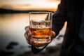 Intriguing closeup Male hand firmly holds a glass of smooth whiskey