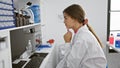 Intriguing portrait of a young, beautiful hispanic woman scientist, engrossed in her lab research Royalty Free Stock Photo