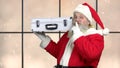 Intriguing Santa holding silver case.