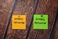 Intrinsic Motivation and Extrinsic Motivation write on sticky notes isolated on office desk Royalty Free Stock Photo