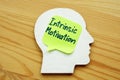 Intrinsic motivation written on a wooden head silhouette Royalty Free Stock Photo