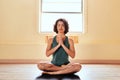 Introduce your heart to harmony. Shot of a young woman meditating during a yoga session.