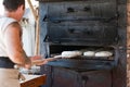 Introducing artisan baker dough in the oven
