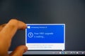 Introducing Windows 10 message on computer display man touching