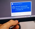 Introducing Windows 10 message on computer display man touching