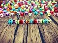 INTRODUCTION word of colourful cube alphabets on wooden background.