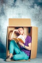 Introvert concept. Man sitting inside box and reading book Royalty Free Stock Photo