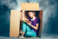 Introvert concept. Man sitting inside box and reading book Royalty Free Stock Photo