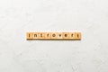 Introvert word written on wood block. Introvert text on table, concept