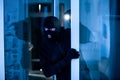 Intruder breaking into apartment or office to steal something