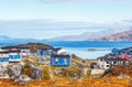 Inuit houses and cottages in residential district of Nuuk city with fjord and mountains in the background, Greenland Royalty Free Stock Photo