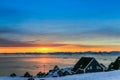 Inuit houses at the fjord with sunset view over the mountains, N Royalty Free Stock Photo