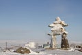 Inukshuk or Inuksuk landmark covered in snow found on a hill in the community of Rankin Inlet, Nunavut