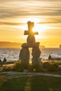 Inukshuk stone sculpture in the sunset time at English Bay Beach, Vancouver City, Canada.