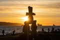 Inukshuk stone sculpture in the sunset time at English Bay Beach, Vancouver City, Canada.