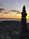 Inukshuk stone statue on the shore at sunset, Jordan River, BC Royalty Free Stock Photo