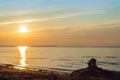 Inukshuk stones on ocean shore at sunset