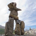 Inuksuk large stacked stones cairn trail marker