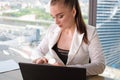 Invalid or disabled young business woman person sitting wheelchair working in office on a laptop Royalty Free Stock Photo