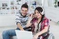 Invalid girl on wheelchair with laptop and friend Royalty Free Stock Photo